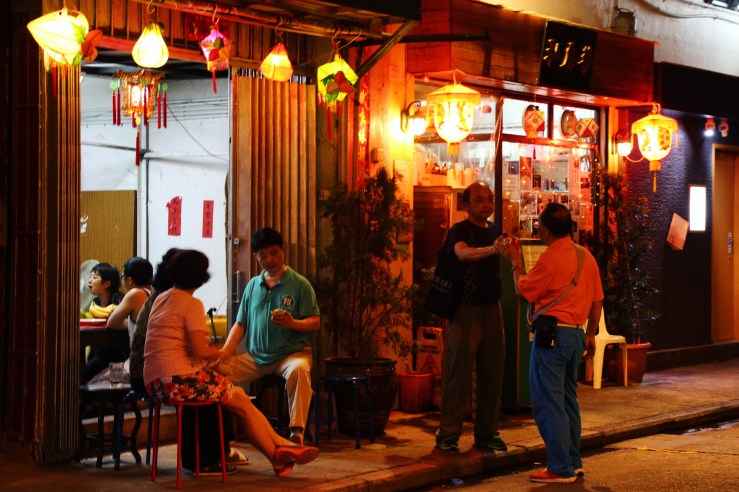 People gather for food and drinks in the back streets of Tai Hang as the fire dragon dance takes place a street over. | Tai Hang Fire Dragon Dance, Tai Hang, Hong Kong | September 27, 2015 | Tanya McGovern
