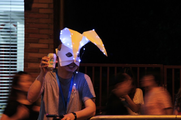 Man with mask poses with beer. | Tai Hang Fire Dragon Dance, Tai Hang, Hong Kong | September 27, 2015 | Tanya McGovern