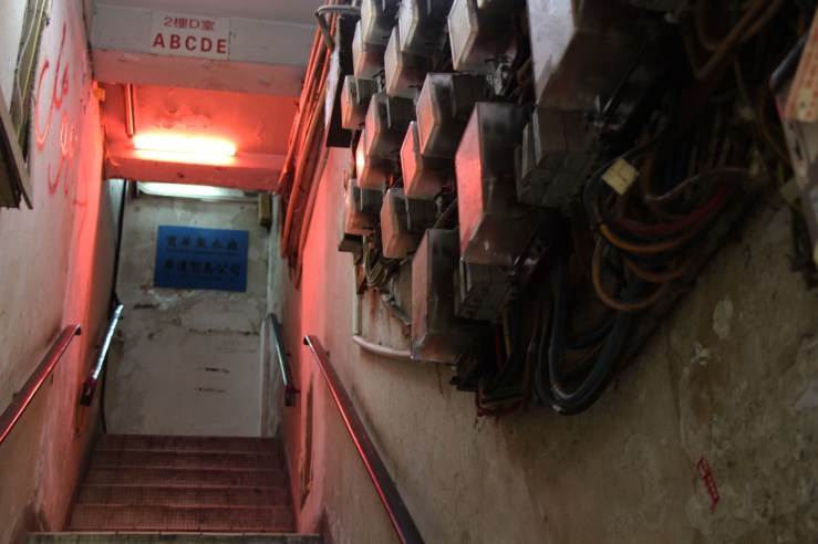 Graffiti and electrical wire line the wall of the stairway. | Tanya McGovern
