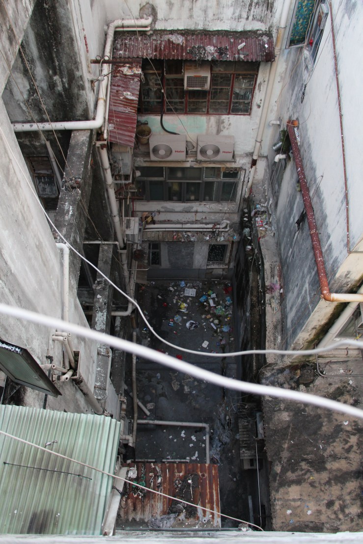 Garbage litters the space between buildings. | Tanya McGovern