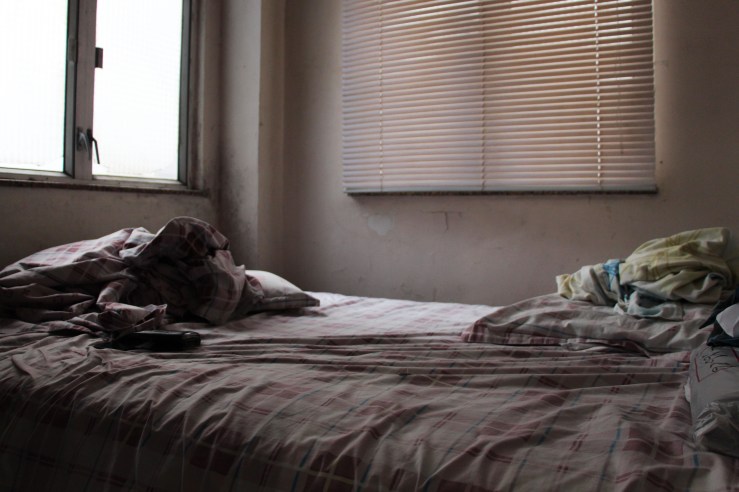 Ushanthan's living space is confined to one room, with a bed and wardrobe filling the entire space. | Tanya McGovern